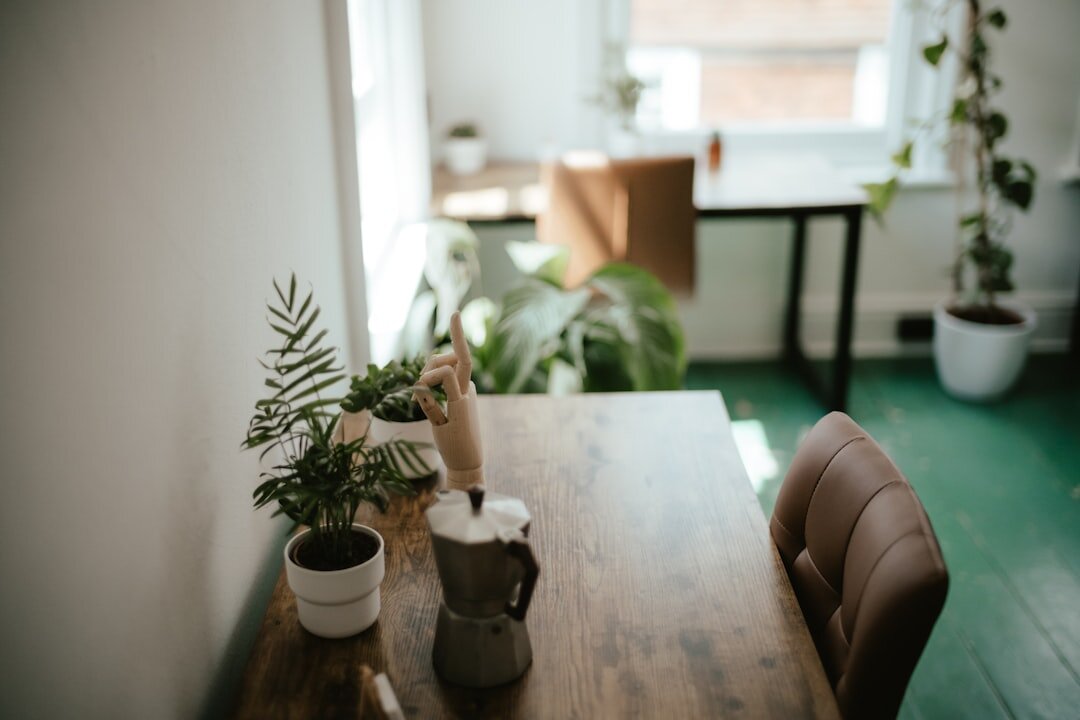 Bright open-plan coworking office with plants and wooden desks